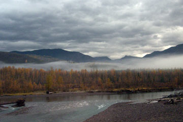 Mountains, river, with low-hanging clouds