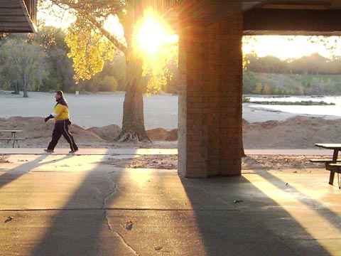 Person walking by pavilions 