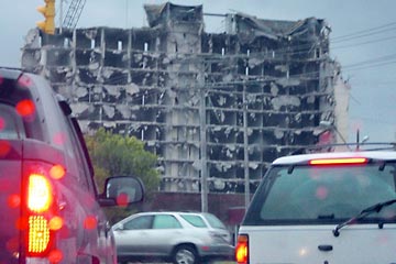 Concrete multi-story building being demolished