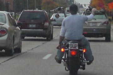 Young man on Harley with gorilla handlebars