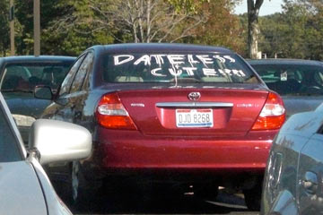 Car with the words dateless and cute on the back window