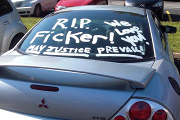 R.I.P. May justic prevail written on car window