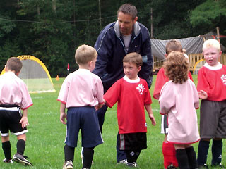 Group of young soccer players shaking hands after the game