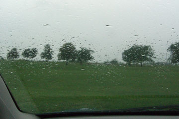 View through car window of rain and clouds