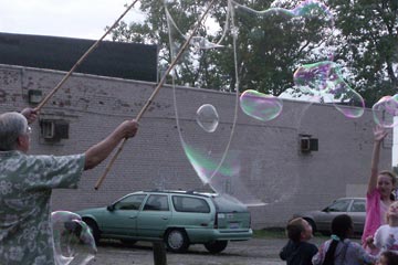 Huge soap bubbles in the air near kids