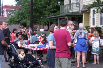 Lots of people talking and eating at outdoor party