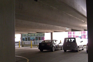 Interior of parking garage with store entrance ahead