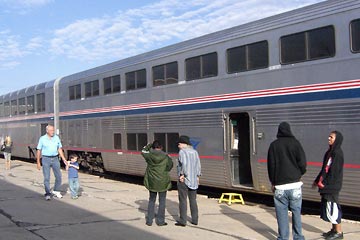 Amtrak train at station with passengers standing alongside