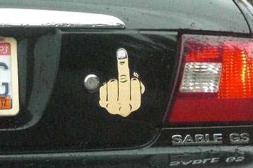 Sticker on back of car: hand giving the finger