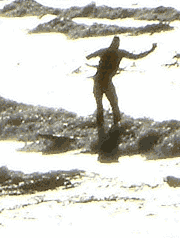 Surfer silhouetted against the waves